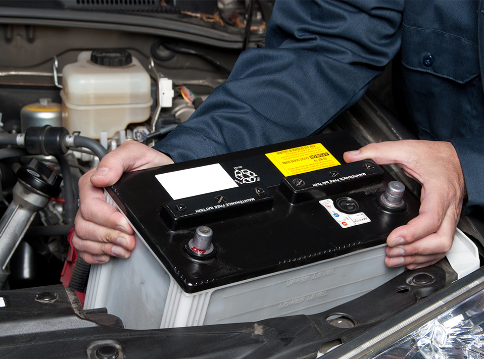 Mechanic fitting a battery - Car Batteries Nailsea